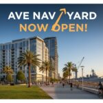 Modern mid-rise apartment buildings at AVE Navy Yard in Philadelphia's Navy Yard district, featuring contemporary architecture, green spaces, and luxury residential entrance.